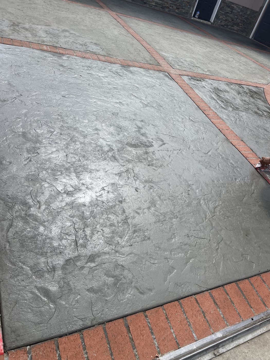 Stamped Slate-Look Patio with Brick Border